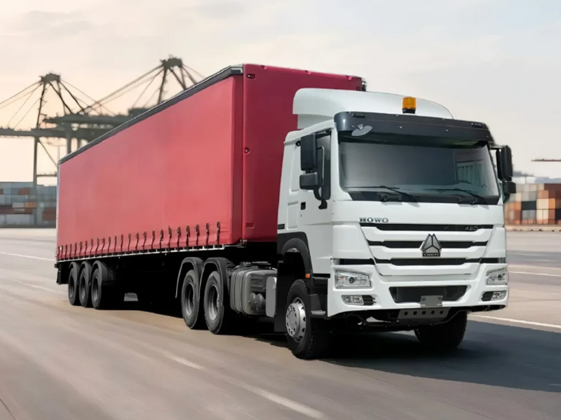 HOWO tractor trucks transporting a container at a port