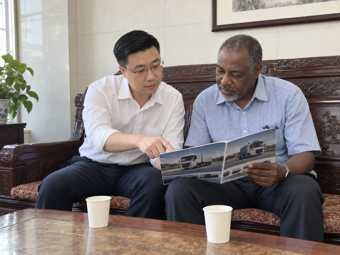International customer reviewing product brochures with a Recheng representative