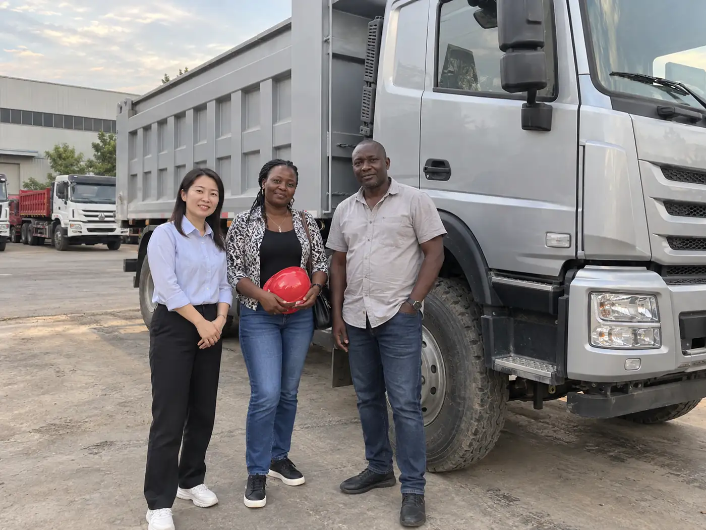 International customers reviewing a heavy commercial vehicle at the factory